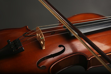 Violinist playing violin on dark background