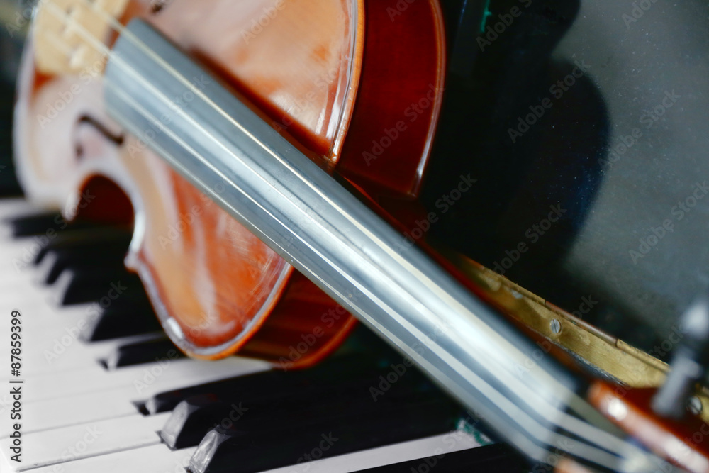 Wall mural violin on piano keys, closeup