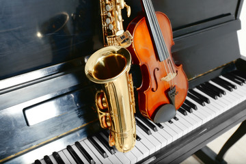 Violin and saxophone on piano background