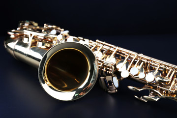 Golden saxophone on dark background