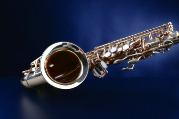 Golden saxophone on dark background
