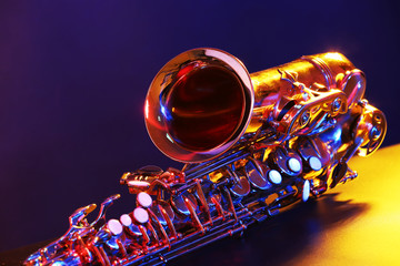 Golden saxophone on purple background