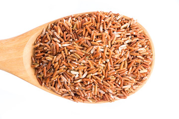 brown rice on wooden spoon isolate on white background.