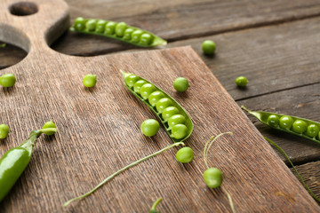 Fresh green peas on wooden background