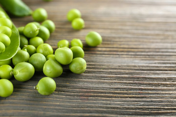 Fresh green peas on wooden table, closeup