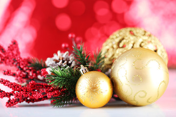 Fototapeta na wymiar Beautiful Christmas balls on red blurred background