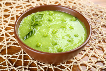 Tasty peas soup on table close up