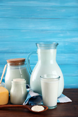 Dairy products on wooden table on blue  background