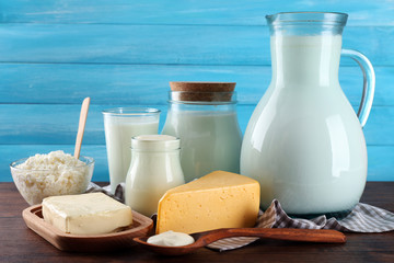Dairy products on wooden table on blue  background