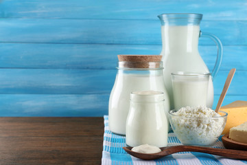 Dairy products on wooden table on blue  background