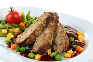 Tasty slices of meat with vegetables on plate close up