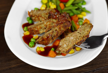 Tasty slices of meat with vegetables on table close up