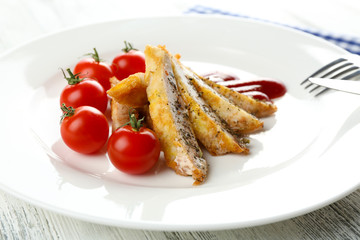 Slices of chicken fillet with sauce and cherry tomato on table close up