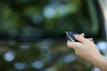 Hand presses on remote control car alarm systems