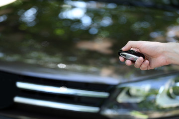 Hand presses on remote control car alarm systems