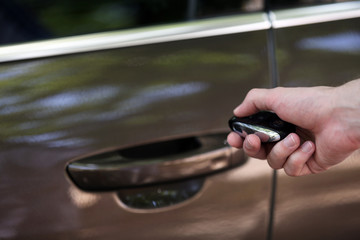 Hand presses on remote control car alarm systems