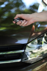 Hand presses on remote control car alarm systems