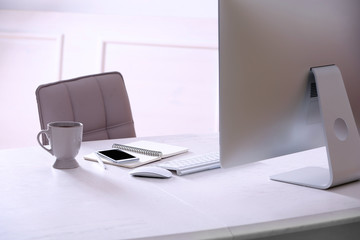 Workplace with computer in room