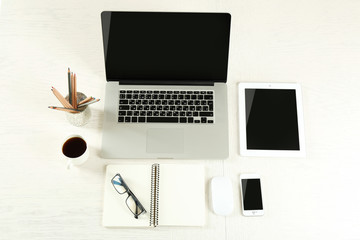 Laptop with tablet and smart phone on Workplace top view