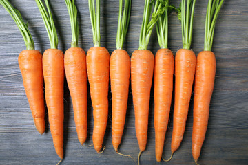 Fresh organic carrots on wooden table, closeup