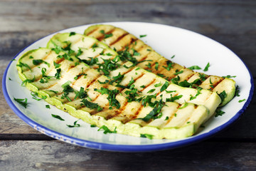 Grilled vegetable mallow in white plate on wooden table, closeup