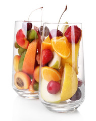 Fresh fruits salad in glasses isolated on white