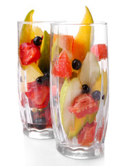 Fresh fruits salad in glasses isolated on white