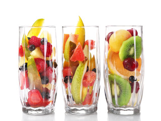 Fresh fruits salad in glasses isolated on white
