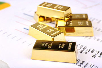 Gold bullion on documents background