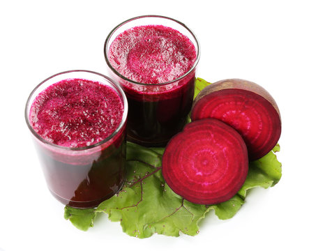 Glasses of beet juice with vegetables isolated on white