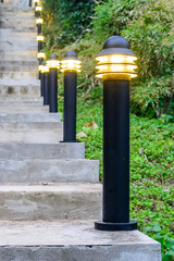 Fototapeta na wymiar lamp and Stairway up the hillside during Twilight.