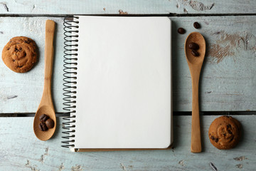 Open recipe book on wooden background