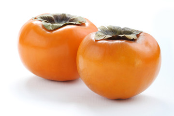 Two Persimmons on white background, macro