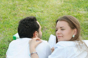 couple of young students studing outside in the park