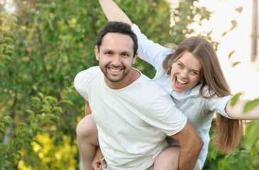 young couple having fun in the garden by their house