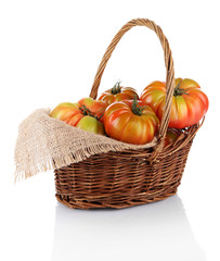 Green tomatoes in basket isolated on white