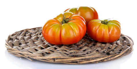 Fototapeta na wymiar Green tomatoes on wicker stand isolated on white