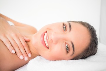 Fototapeta na wymiar Beautiful young woman on massage table at spa center