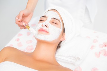 Attractive woman receiving a cream treatment 