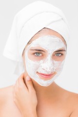 Attractive woman having white cream on her face