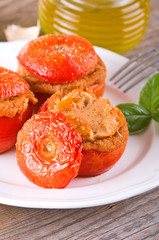Stuffed tomatoes on a white plate. 