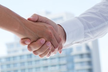 Close up view of two business people shaking hands