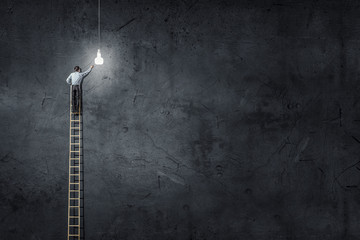 Businessman on ladder