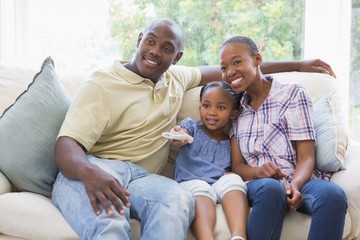 Happy smiling family watching television