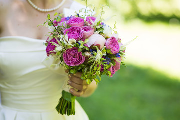 Fototapeta premium Colourful bridal bouquet in hand of bride