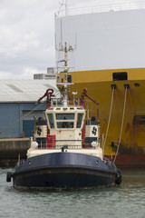 Tug pulling ship from a berth