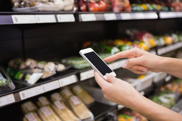 Woman buy products and using his smartphone 