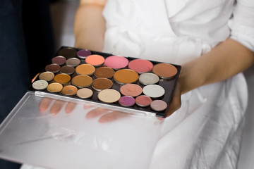 Box with makeup in the hands of a girl