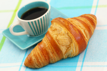 Black coffee and freshly baked croissant
