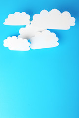 White paper clouds on blue background. Cloud computing concept.